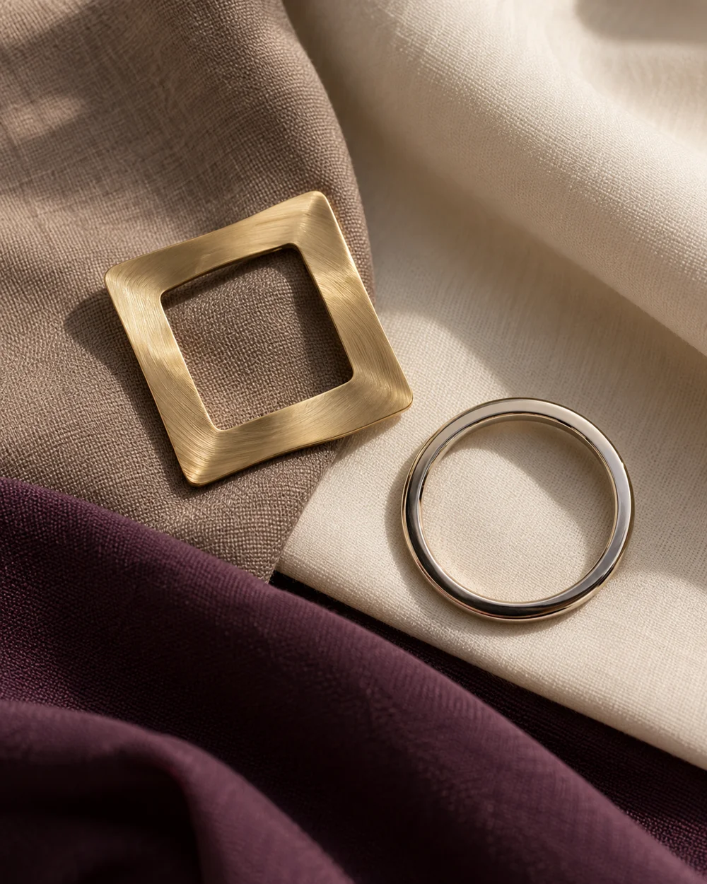 Geometric brooches with neutral fabric swatches — AI-generated editorial concept